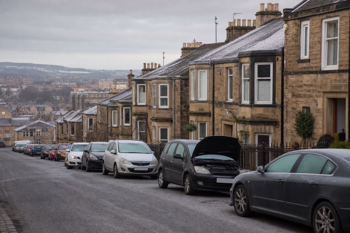 Cold-start car with open bonnet on an Edinburgh hillside street